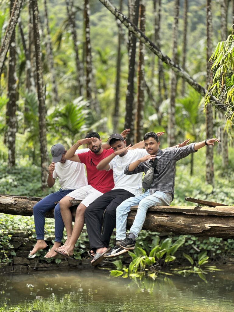 Trekkers crossing a stream during the Netravati Peak Trek