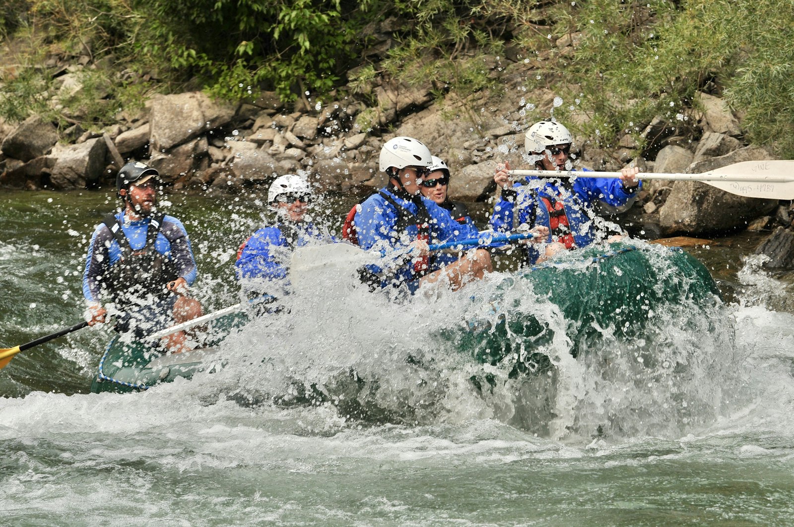 Team whitewater rafting together in Dandeli